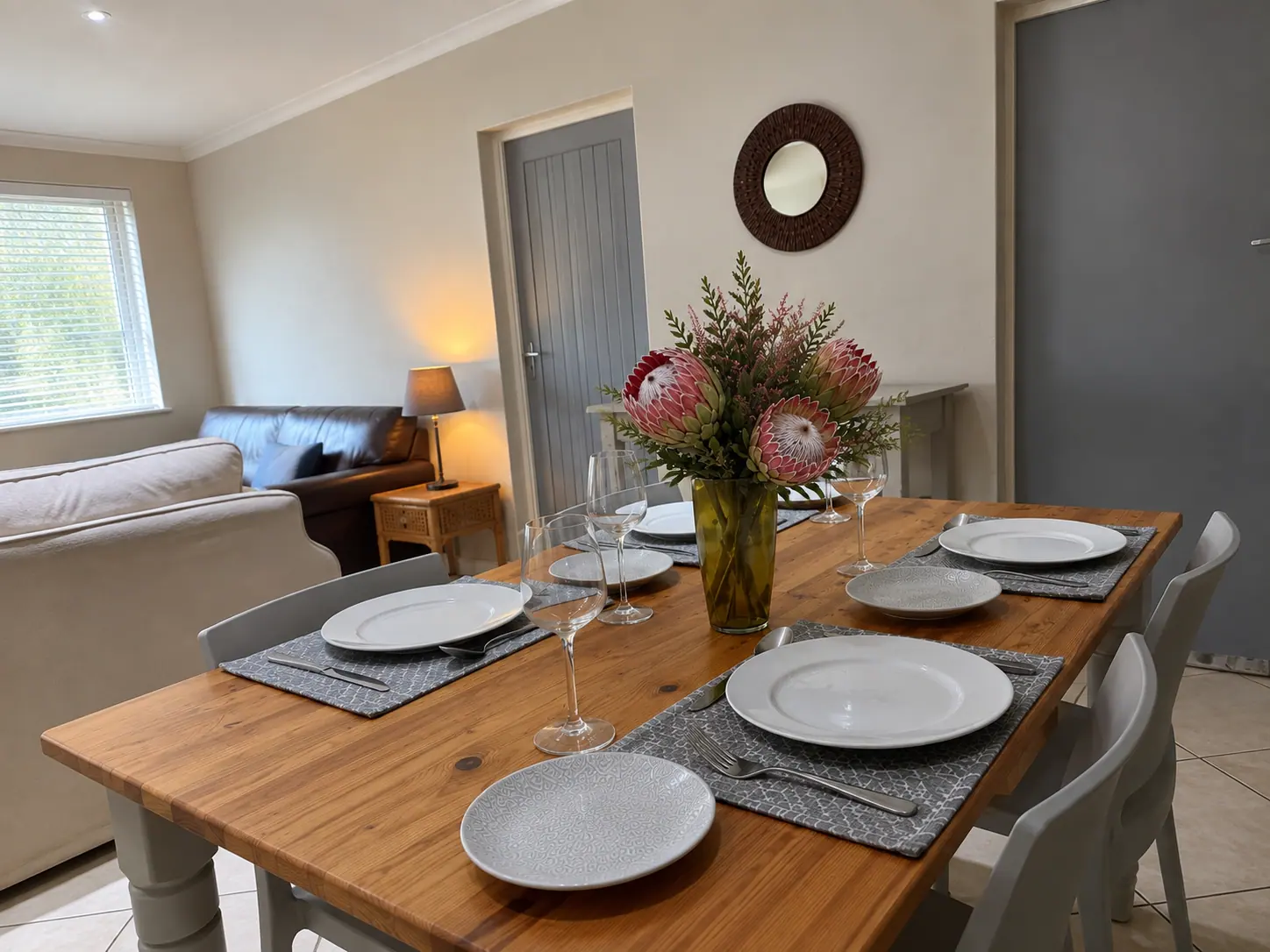 Dining table with proteas opening into the living room