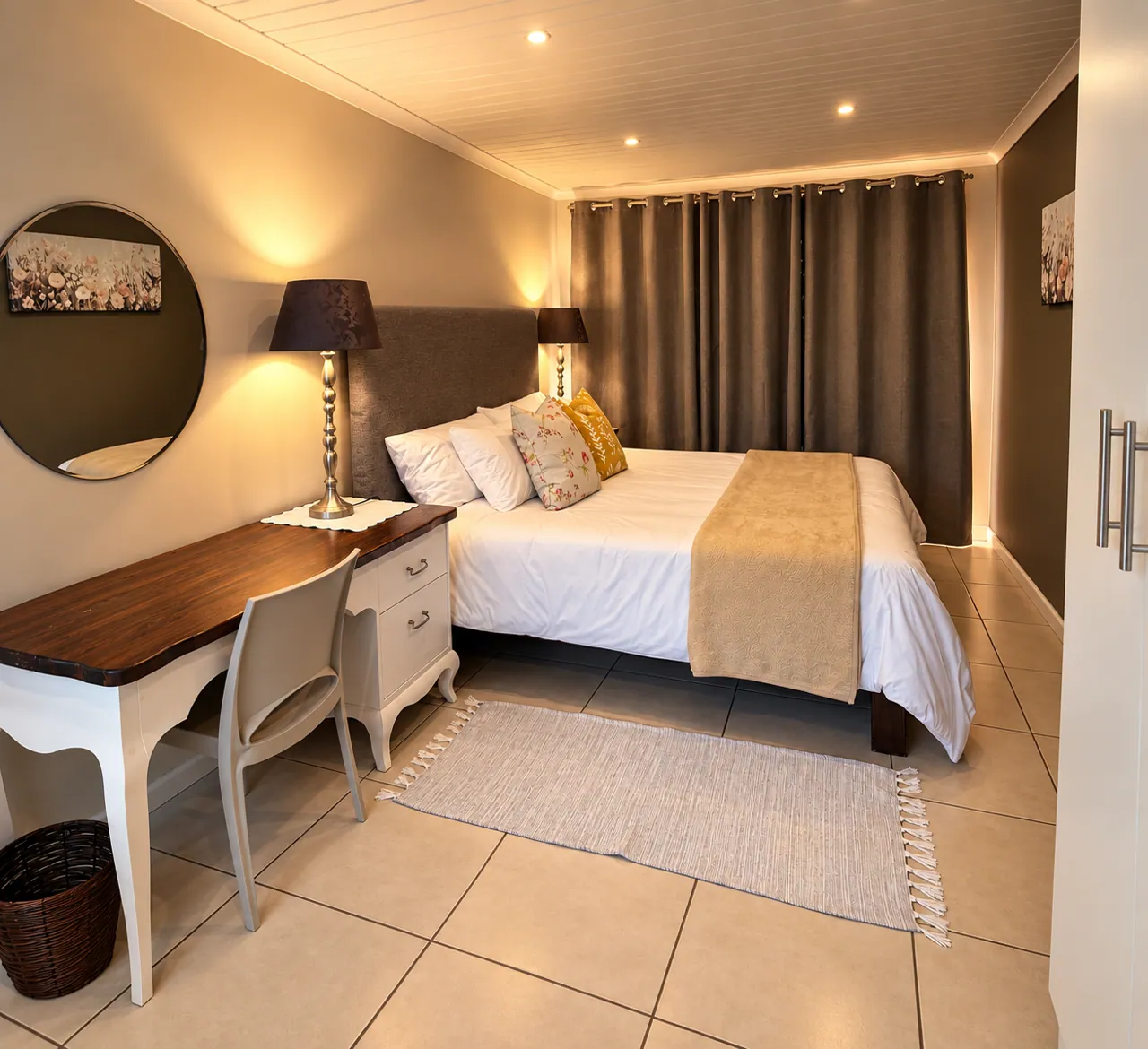 Main bedroom with soft linen and warm lamp light